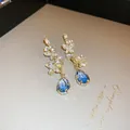 Close-up view of elegant butterfly earrings with blue teardrop stones and crystals - 7# 925 Sterling Silver Earring Post Style