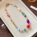 Close-up of colorful dopamine style ceramic and glass bead necklace in a gift box - Colorful