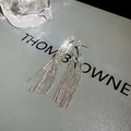 Detailed view of elegant silver metallic tassel earrings with s925 needle for women - Knotted Tassel Style / Silver