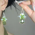Close-up detail of elegant green crystal flower tassel earrings with large teardrop stones - 3# Ear Hook Style