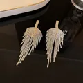 Close-up detail of elegant silver needle earrings with shimmering rhinestone long tassels - Leaf Slice Tassel (22#)