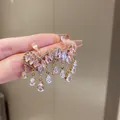 Detailed view of gold-plated heart earrings with sparkling pink teardrop crystals - Pink Heart Tassel Style (41) / Pink