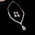 Detailed view of luxury pear-cut crystal necklace and earrings set on black surface. - Waterdrop Style (HN3816) / Silver