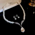 Close-up of elegant rhinestone pearl necklace and earring set with water-drop pendant. - French Vintage Pearl Jewelry Set / Necklace And Earrings Set / Silver