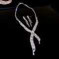 Detail view of a sparkling rhinestone tassel necklace and earrings set in silver finish - Cross Tassel Style (HN3816) / Silver