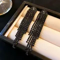 Elegant black rhinestone long tassel earrings with silver needles, minimalist luxury style. - Black Waterfall Tassel Style