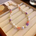 Close-up detail of handmade baroque pearl necklace featuring colorful seed bead flowers - Necklace-Pink-Purple