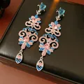 Elegant long tassel earrings with pink and blue rhinestones on a black box - Pink and Blue Heart Tassel Style