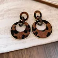Detailed close-up of vintage leopard print double hoop drop earrings with gold finish. - Gold Brown Double Hoops