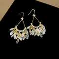 Macro detail of 18k gold plated earrings with sparkling marquise cut zirconia - Gold