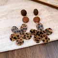 Close-up of vintage leopard print flower earrings with wooden accents in Maillard style - Coffee-Flower
