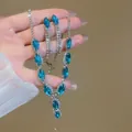 Close-up of sparkly zircon necklace and earring set with blue marquise stones. - 77# Necklace - Blue - Two-piece Set