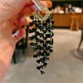 Elegant gold hoop earrings with cascading black heart-shaped tassels for women's fashion - Ring Heart Tassel (8)