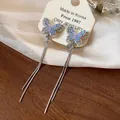 Close-up detail of fairy zircon butterfly tassel clip-on earrings with blue wings - Tassel Ear Cuff / Silver (Blue Purple Butterfly)