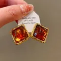 Vintage square brown tiger eye resin stud earrings with elegant gold textured trim - Square