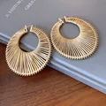 Elegant large gold-toned circular earrings with a radiant pleated texture for women - Large / Gold