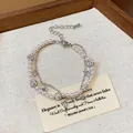Detailed view of the double-layer pearl bracelet featuring zircon stars and elegant charms - Double Layer Design / Silver