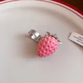 Detailed close-up view of a sweet pink resin strawberry ring with stainless steel band - Open Ring