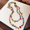 Detailed view of a bohemian multi-layered colorful crystal and shell beaded necklace style - Yellow-Blue-Purple