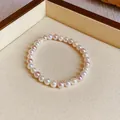 Elegant pearl elastic bracelet with mixed white and pink pearls on display tray - Bracelet / 6mm Bead Diameter / Pink