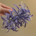 Detailed view of the purple fabric spider lily hair claw clip's intricate petals. - Purple Flower Hair Claw