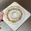 Primo piano di un elegante bracciale di perle con pietre occhio di gatto e accenti dorati - Stile Ciondolo Occhio di Gatto (Bracciale 73#) / Stile Zirconia (Con squisita confezione regalo) / Oro