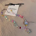 Close-up of handmade colorful beaded necklace featuring star and butterfly charms - Necklace Style 25 / Colorful