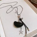 Macro detail of a holiday style necklace featuring black leather shell and metal star pendants - 29# Necklace - Leather Star Tassel Style / Black-Silver