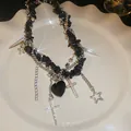 Detailed view of a gothic black stone necklace with silver cross and heart charms on a plate - 30# Necklace - Gothic Cool Pendant Style / Silver-Black