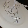 Detailed view of white lace choker and silver layered necklaces with cross pendants - 32# Necklace - Lace Bow Sweet & Cool Style / Silver-White