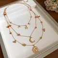 Detailed view of triple-layered celestial gold necklace with sun, moon, and star pendants - 51# Necklace (Gold)