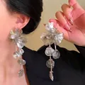 Detailed view of elegant silver leaf petal tassel earrings worn by a fashion model - Classic Leaf Petal Tassel Style (Silver Post)