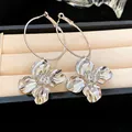 Elegant silver flower hoop earrings displayed in a luxury jewelry box detail view - Flower Dangle Style (Silver Post)