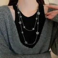 Elegant double layered silver necklace with hollow star pendants worn by an Asian model - 37# Necklace - Hollow Star / Silver