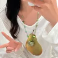 Hand-woven vacation style necklace with green beads on model for SKU display - 73# Plaid Pendant Handmade Woven Necklace (HN8438) / Green