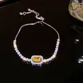 Silver-toned adjustable bracelet with a radiant yellow rectangular zircon center - Square Style (15#)