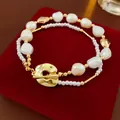 Bracelet de perles élégant de style français avec perles dorées sur velours rouge. - Style T-bar Double Couche Perle Irrégulière Perle de Rocaille / Or