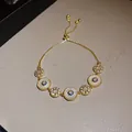 Elegante bracciale occhio di Allah dorato con zirconi lucidi e inserti in madreperla. - Bracciale Scorrevole Occhio del Sole Malocchio (55#) / Oro