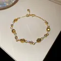 Elegante bracciale vintage dorato con pietre ambrate ovali e dettagli in zirconi - Bracciale con Ciondolo a Cuore Gemma Ambra (63#) / Bianco-Verde