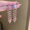 Detailed macro view of vintage pink zircon tassel earrings showcasing brilliant fire and sparkles - Vintage Palace Style