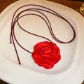 Detailed view of a sweet red fabric rose choker necklace with thin dark red cords. - Red