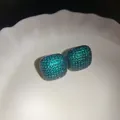 Close-up detail showing the intricate green cubic zirconia pavé on square stud earrings. - Pave Square Style (11#)