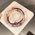 Detailed view of layered beaded bracelets featuring flower charms and garnet beads on wood - Style 13 (Double Layer) / Multicolor-Deep Red
