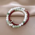 Detailed macro shot of elegant double-layered beaded stone bracelets on silk fabric - Style 14 (Double Layer) / White-Green-Red