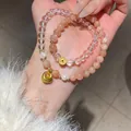 Elegant stacked sunstone and clear crystal beaded bracelet featuring gold-tone coin charms. - Style 35 (Sunstone) / Gold-Clear