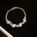 Close-up of an irregular zircon oval buckle bracelet on black velvet background - White Oval Zirconia / Silver