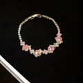Close-up of pink oval zircons and clear stones on an elegant silver-toned bracelet - Pink Oval Zircon / Silver