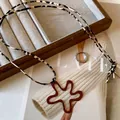 Detail view of a vintage geometric flower pendant with chic leopard print cord necklace - Brown-Red