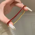 Elegantes vergoldetes Tennisarmband mit leuchtend roten Zirkoniasteinen für Damen. - Rotes Zirkonia Tennis Schiebe-Armband / Gold-Rot