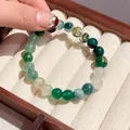 Elegant multi-bead green tiger eye stone bracelet displayed in a vintage wooden box - Style 55 (Rune Decor) / Green